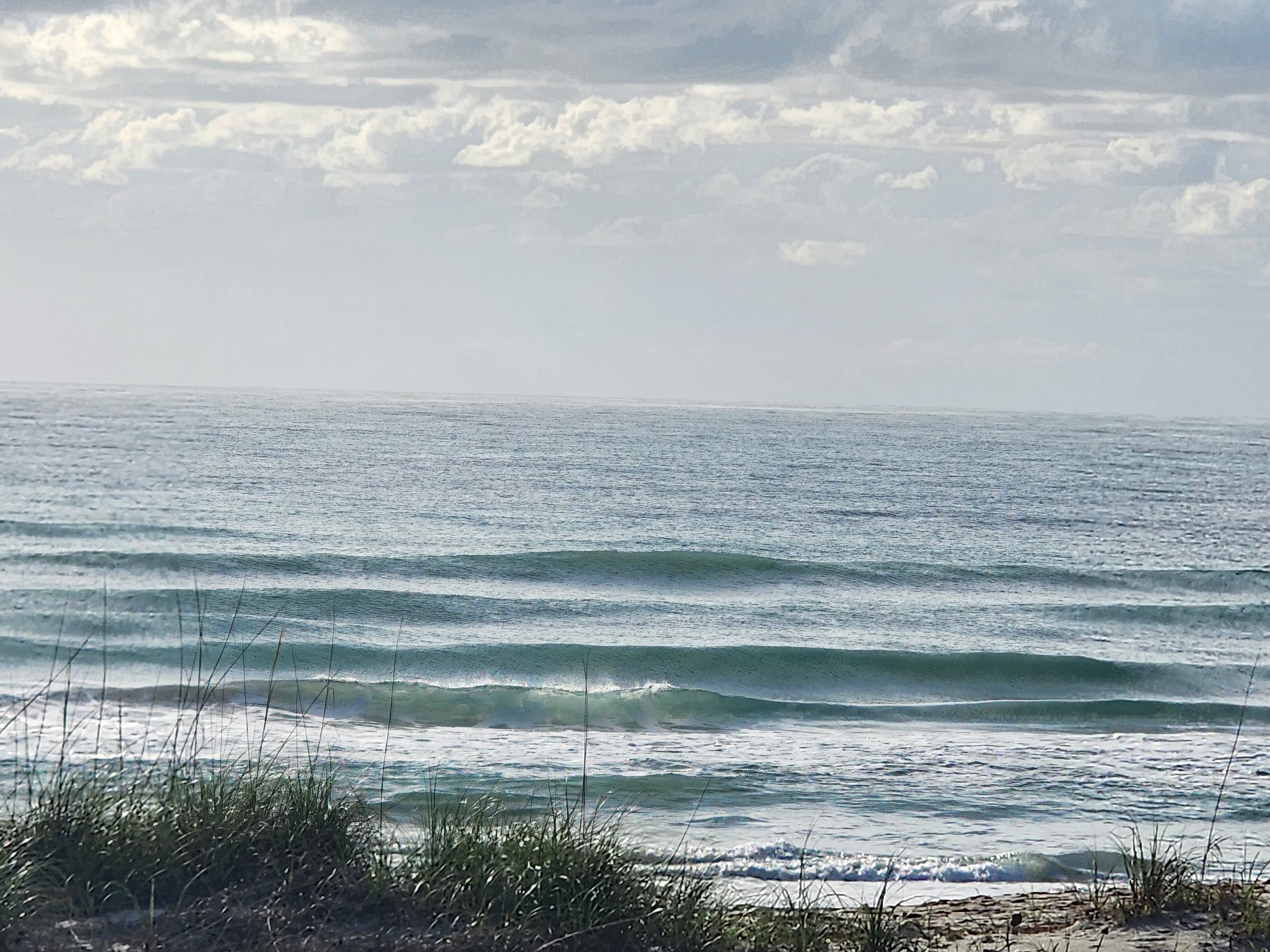 Glassy 1-2 foot surf with W winds at Picnic Tables South Cocoa Beach April 24