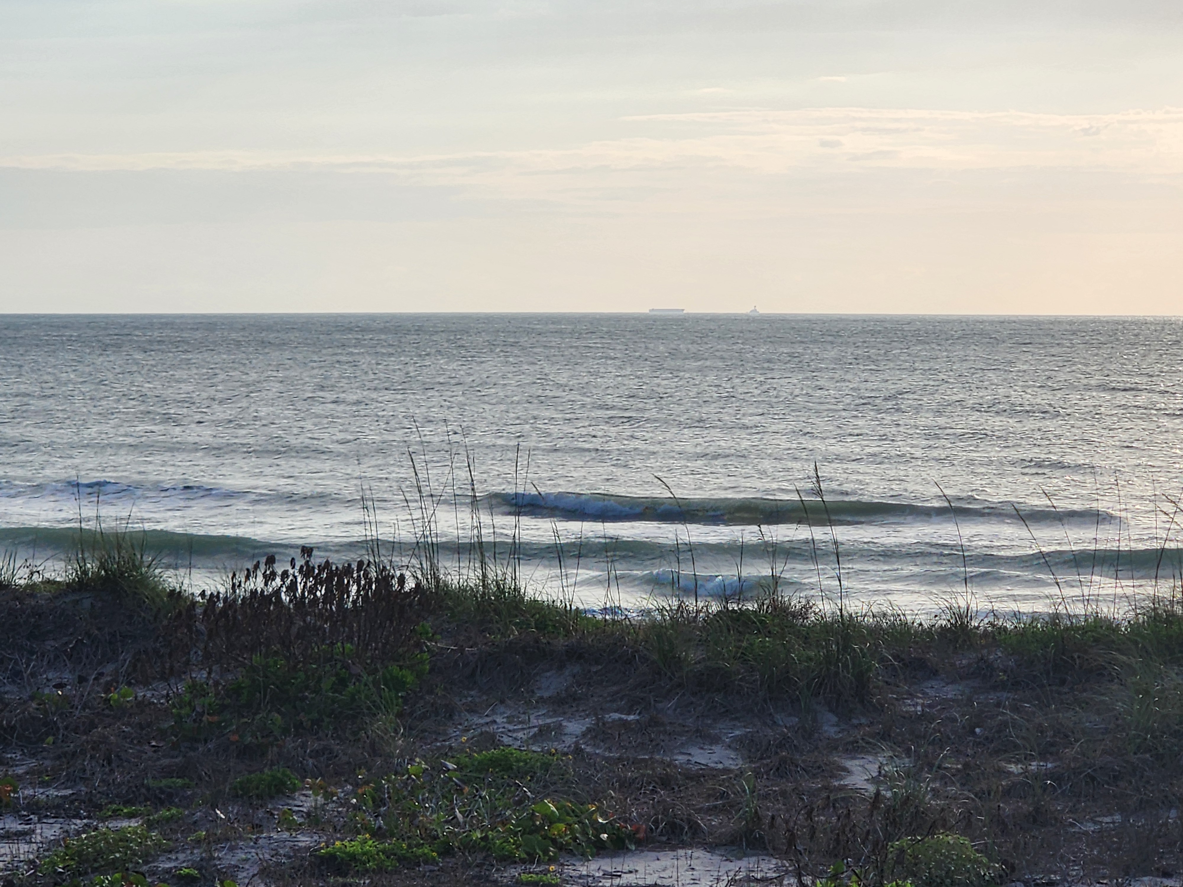 Morning light on small 1 foot surf with wind texture at 31st Street South Cocoa Beach