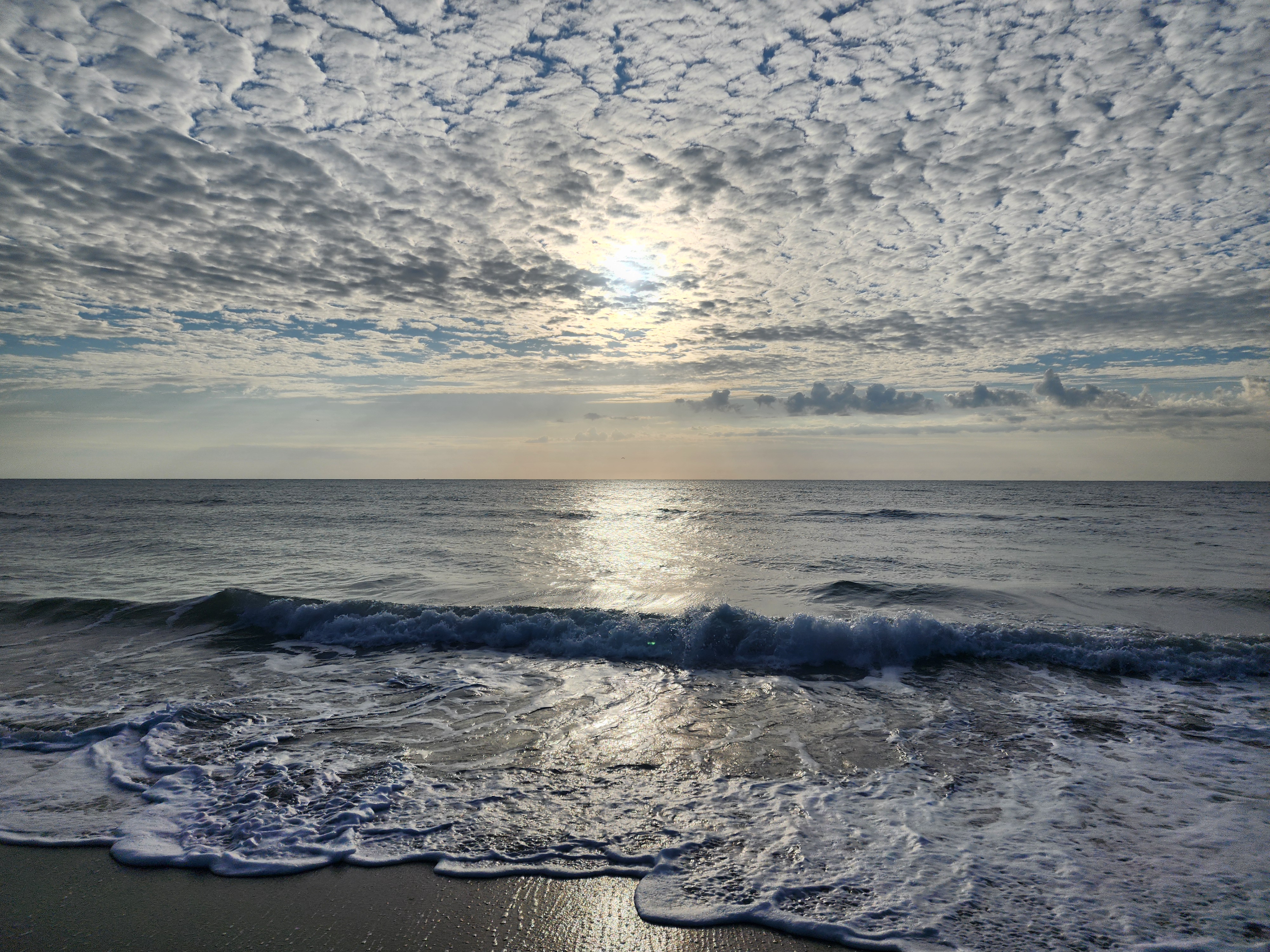 Beach day scene at Picnic Tables South Cocoa Beach with small surf and clear skies April 26