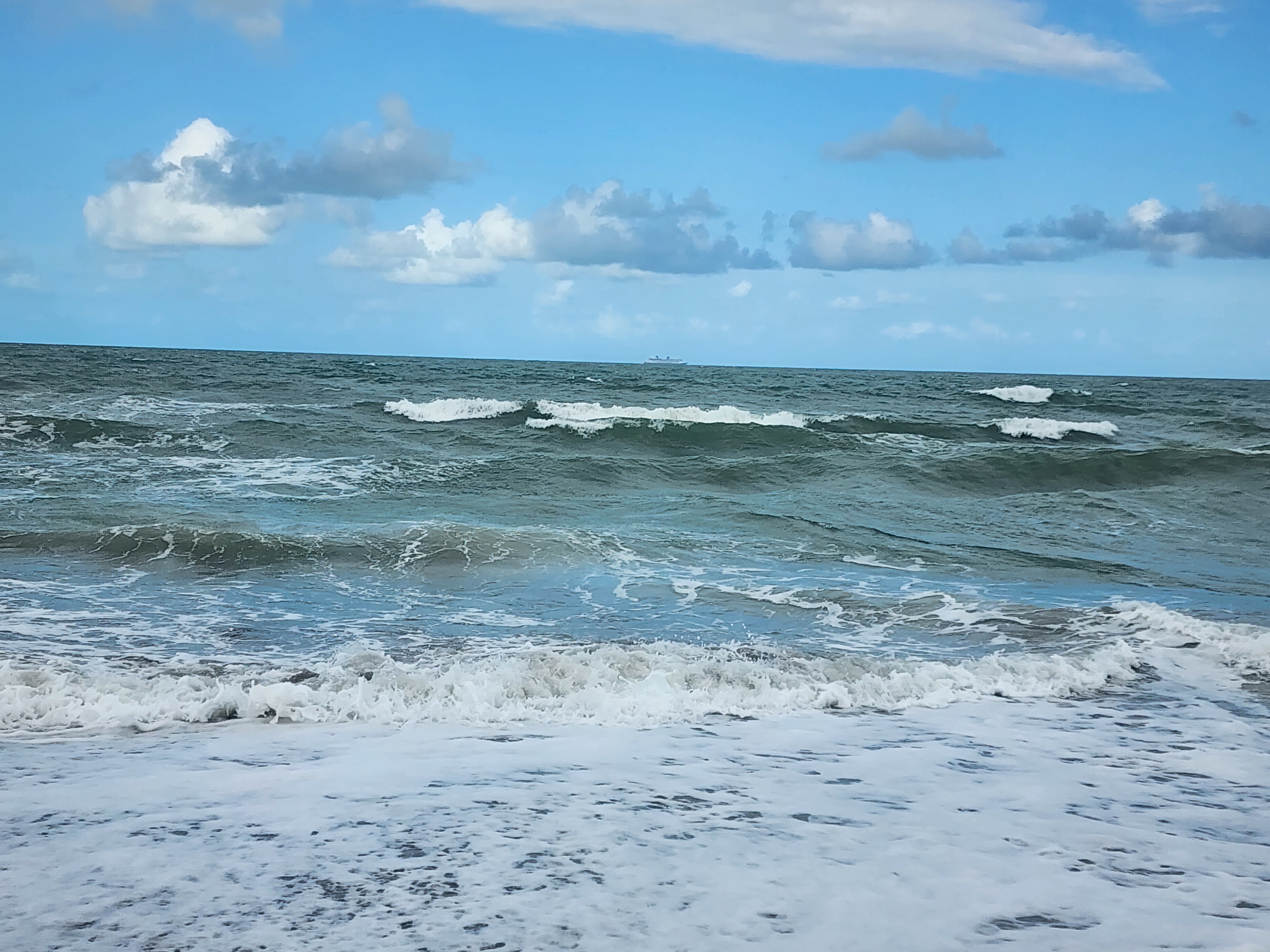 Small wave breaking into shore at Picnic Tables South Cocoa Beach flat conditions April 27