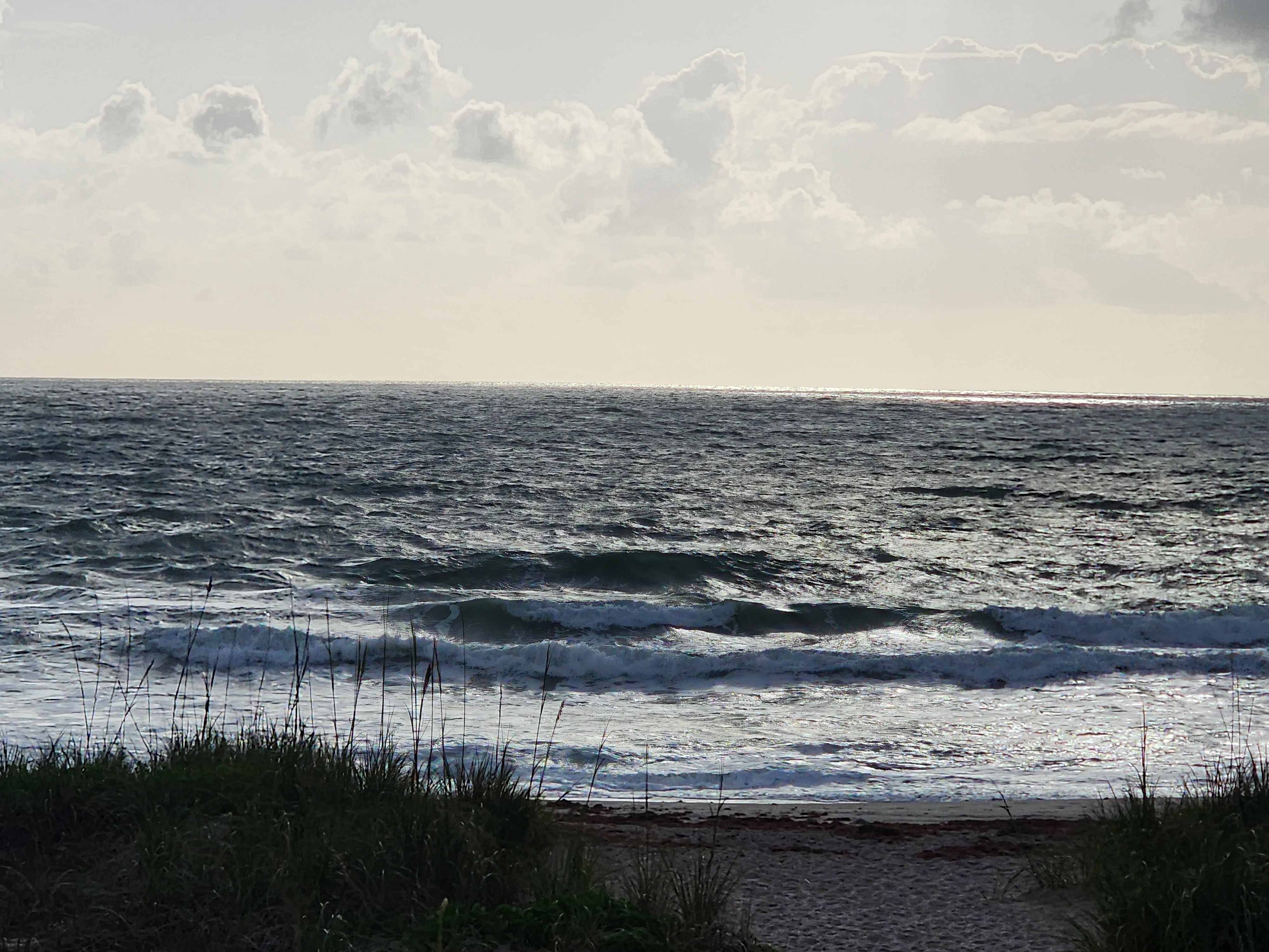 Textured 1-2 foot surf at Picnic Tables South Cocoa Beach light onshore winds April 28