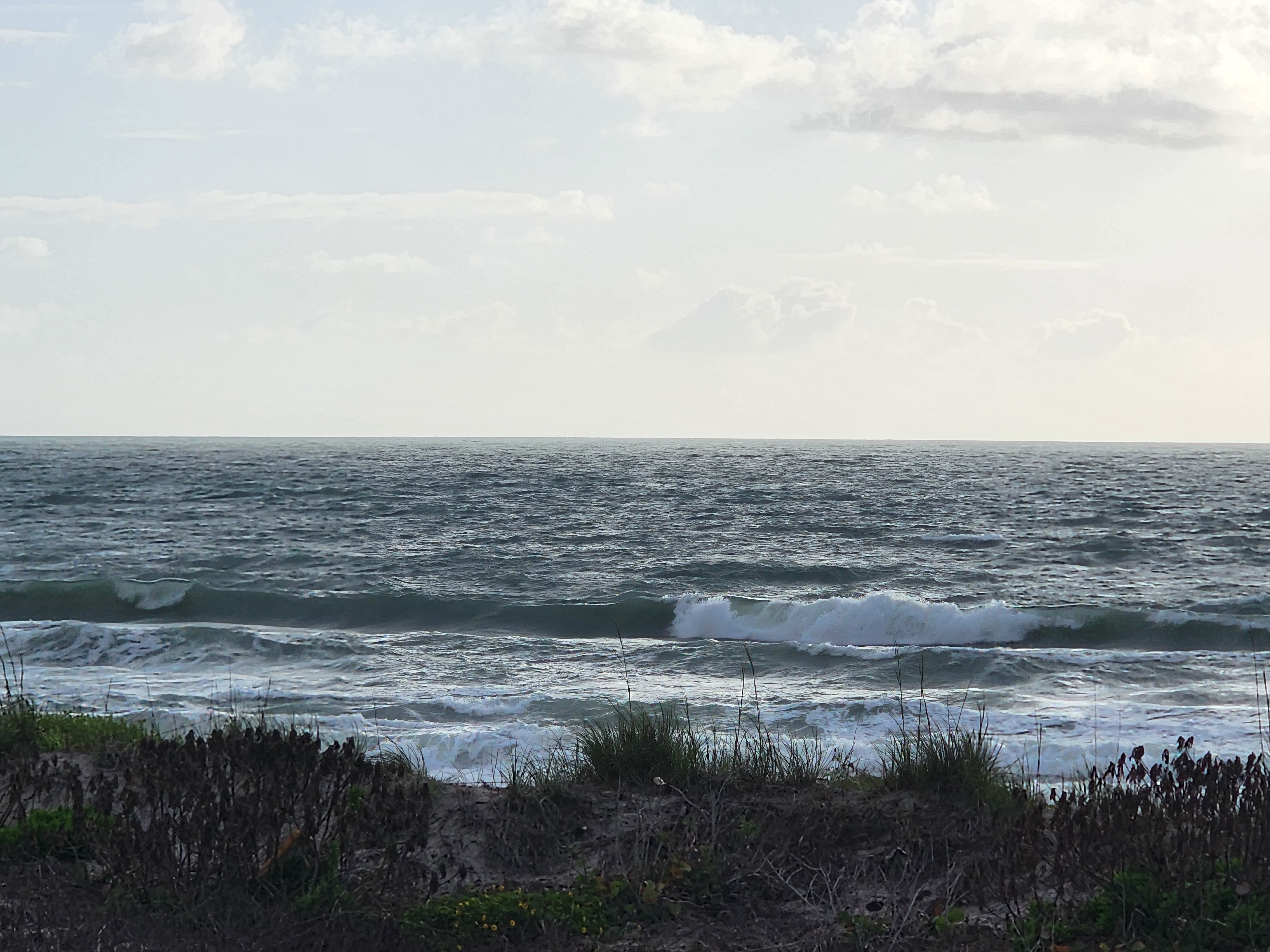 Morning light on slightly bumpy 1-2 foot surf at Picnic Tables South Cocoa Beach