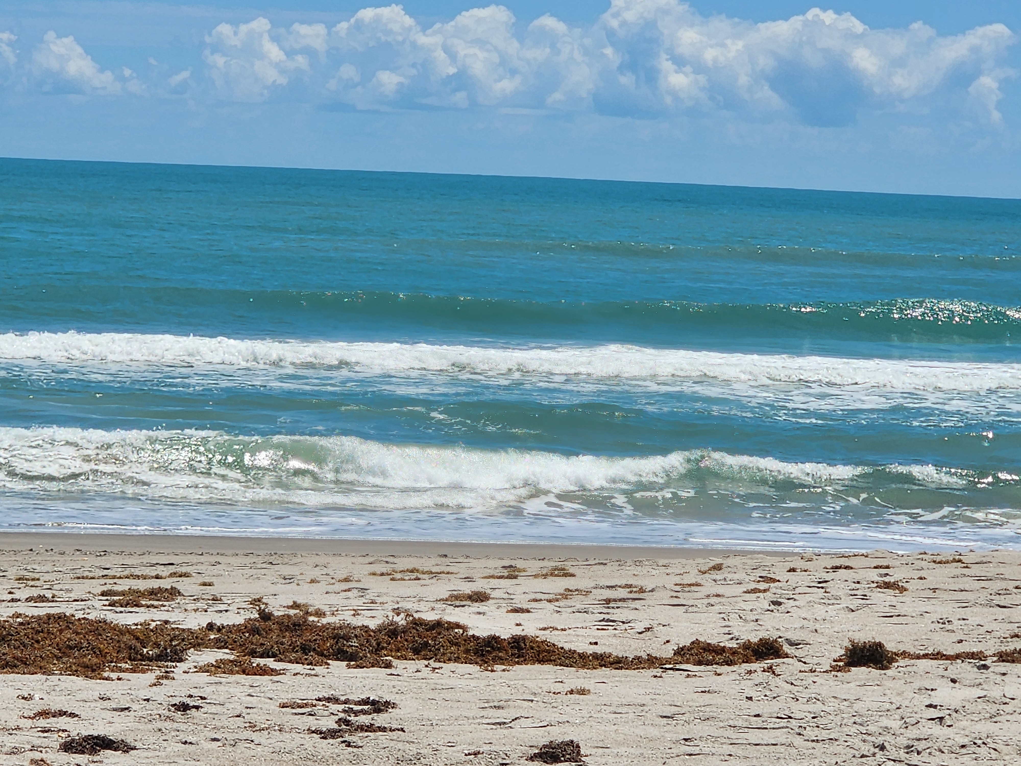 Golden hour light on glassy small surf at Picnic Tables South Cocoa Beach SSW winds