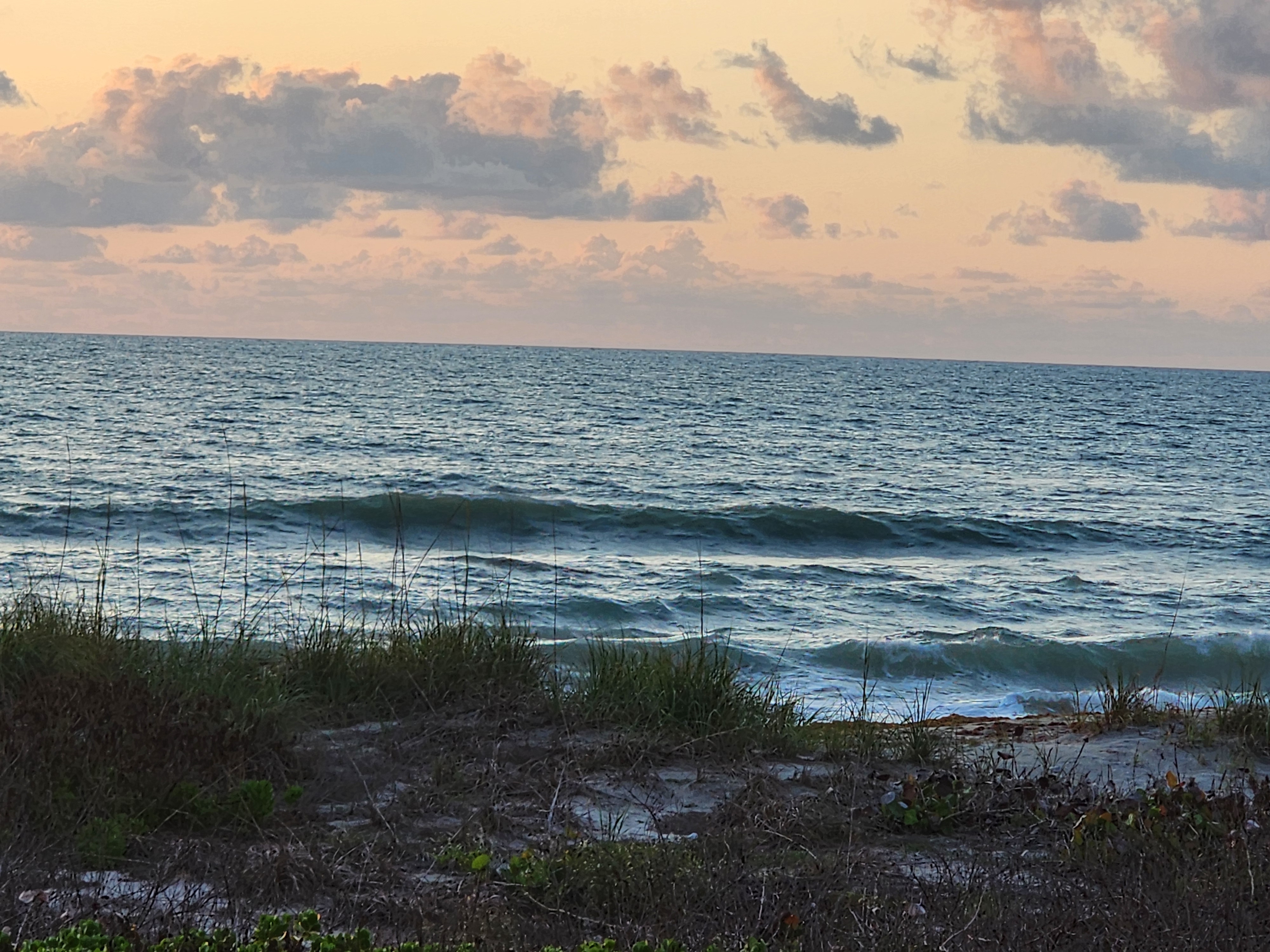 Glassy 1-2 foot surf with golden morning light at Picnic Tables South Cocoa Beach