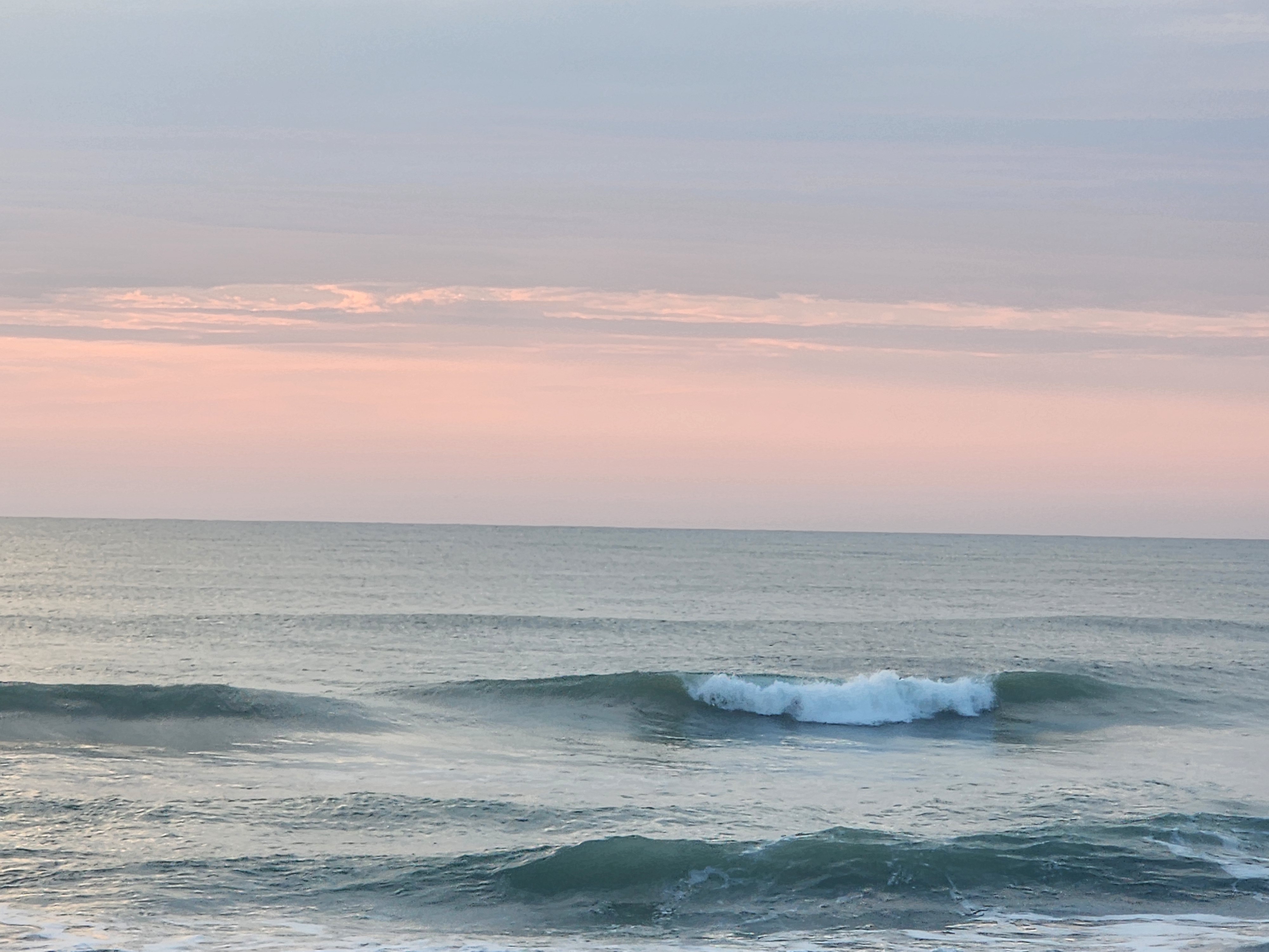 Clean offshore lines with golden morning light at 31st Street Cocoa Beach high tide glassy conditions