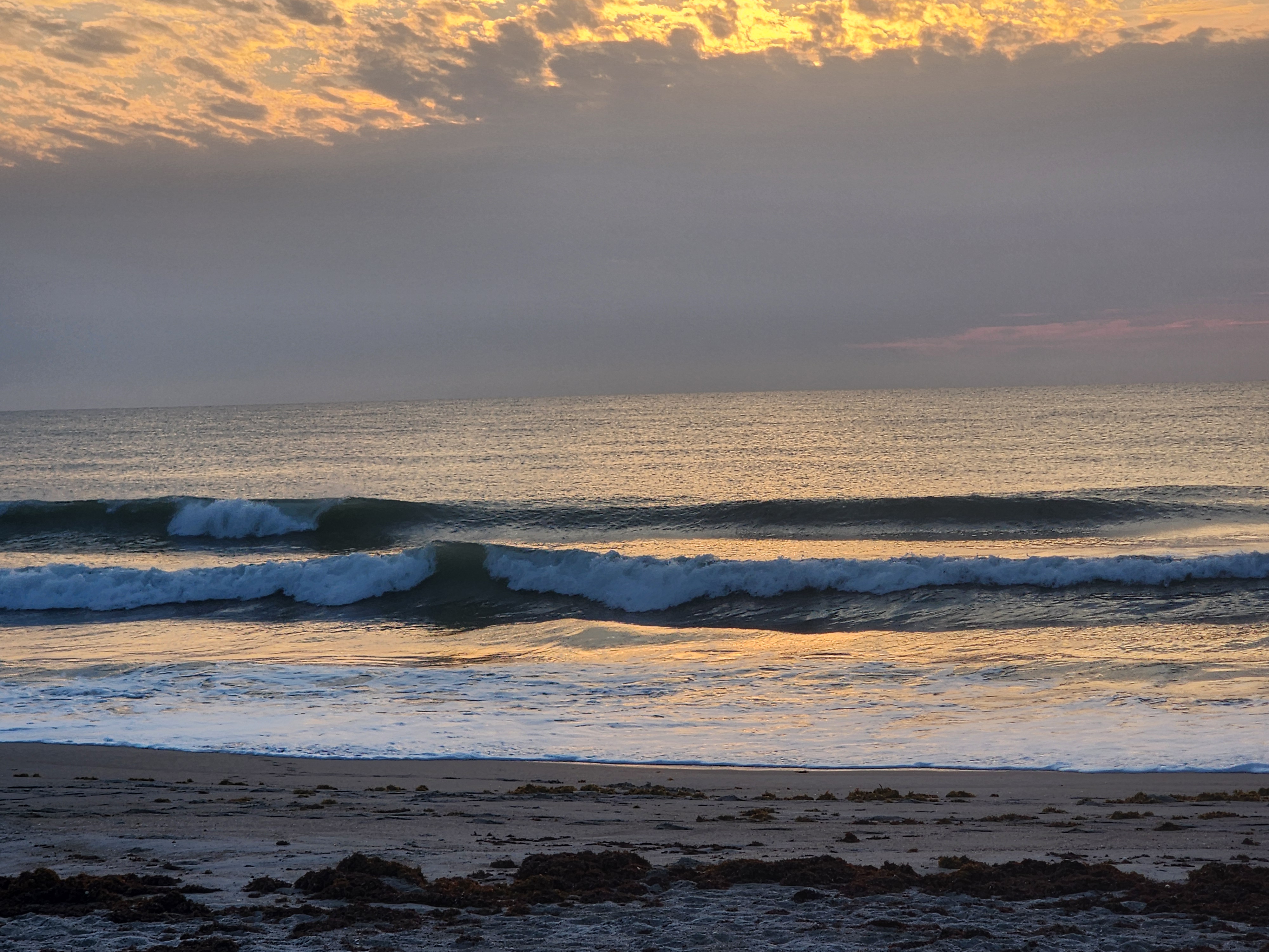 Morning glass at Picnic Tables with clean offshore surf and sea oats framing the view South Cocoa Beach