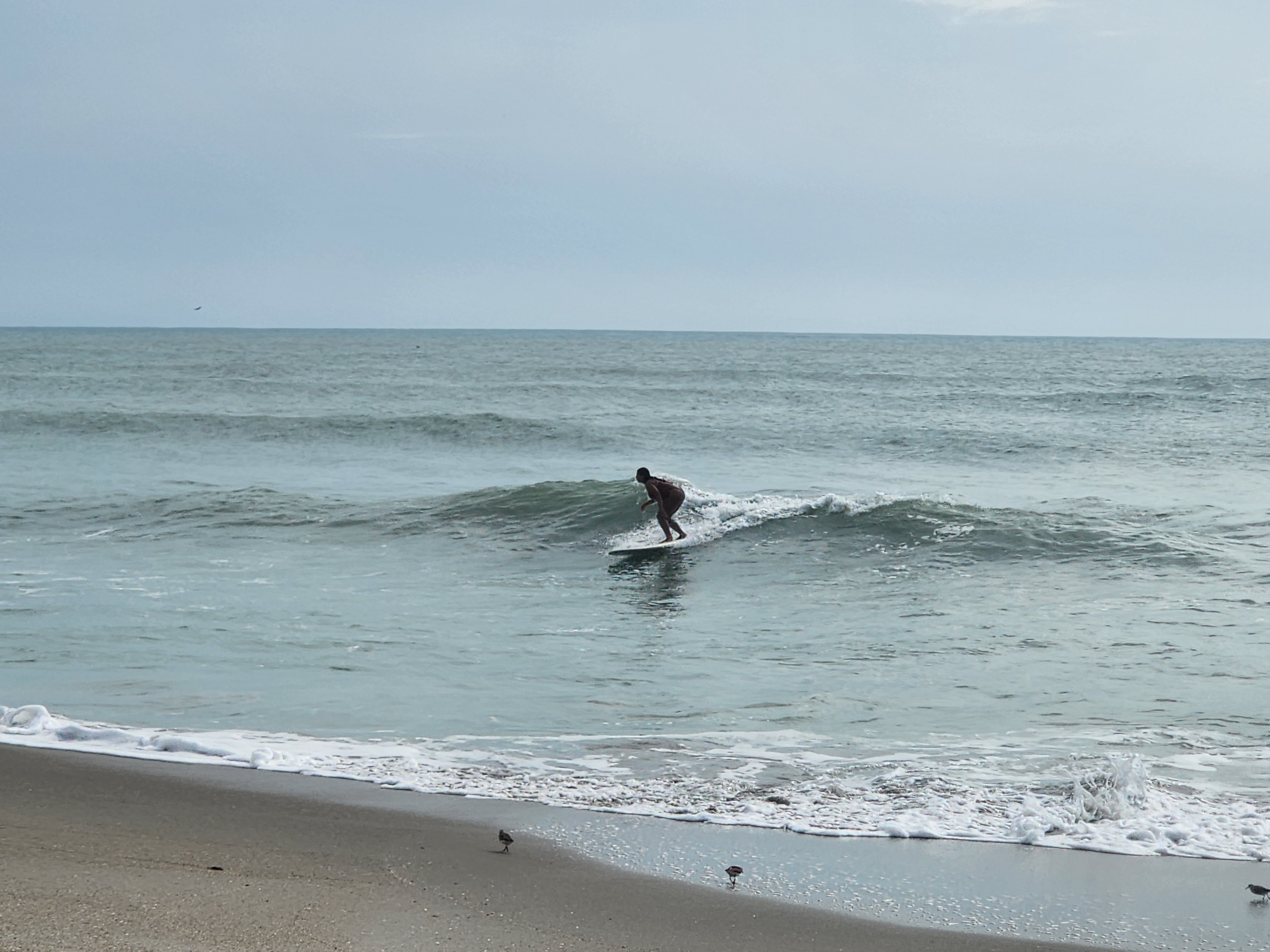 Clean 2 foot wave with offshore spray at Picnic Tables South Cocoa Beach evening glass-off