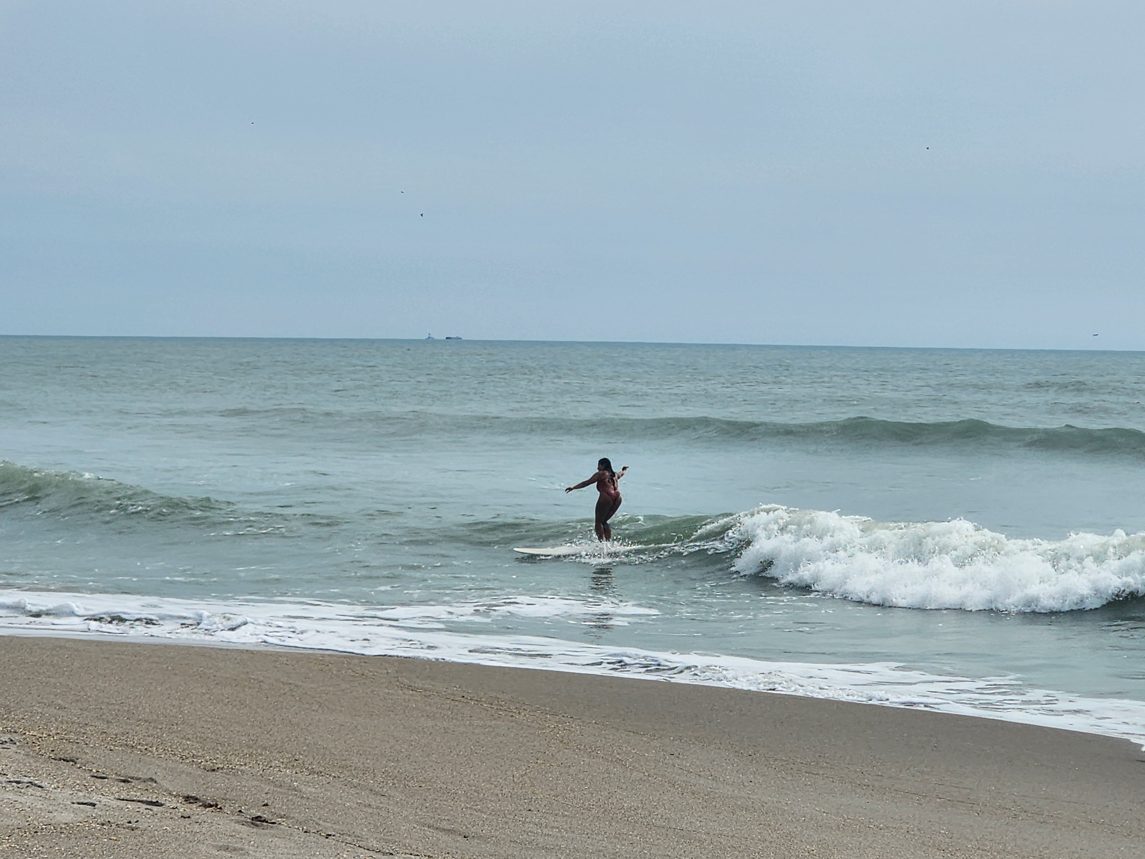 Glassy afternoon surf with offshore winds grooming 2 foot waves at Picnic Tables South Cocoa Beach