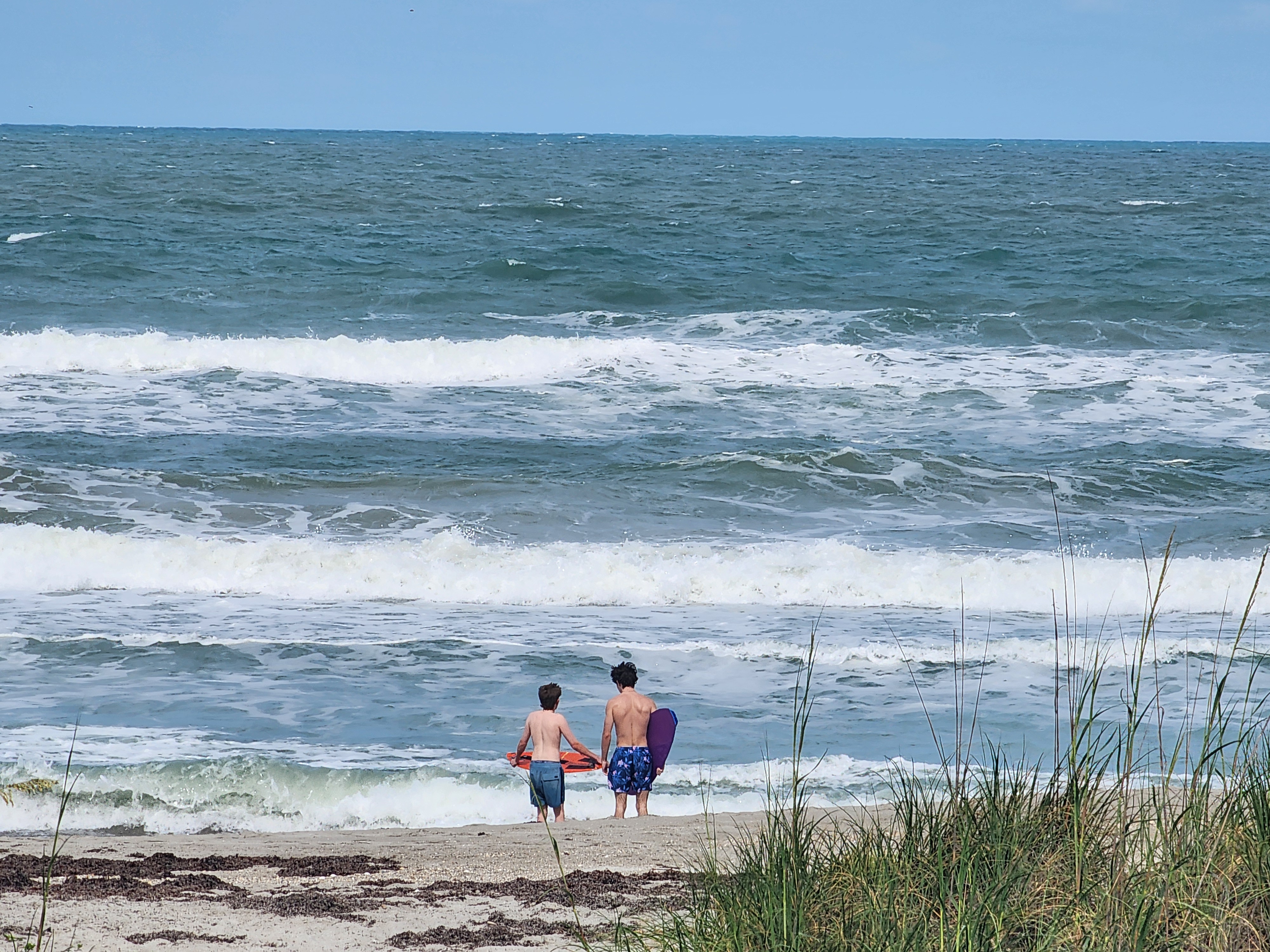 Blown out 3-4 foot surf with whitecaps and 20 mph wind gusts at Picnic Tables South Cocoa Beach May 4 2026 afternoon