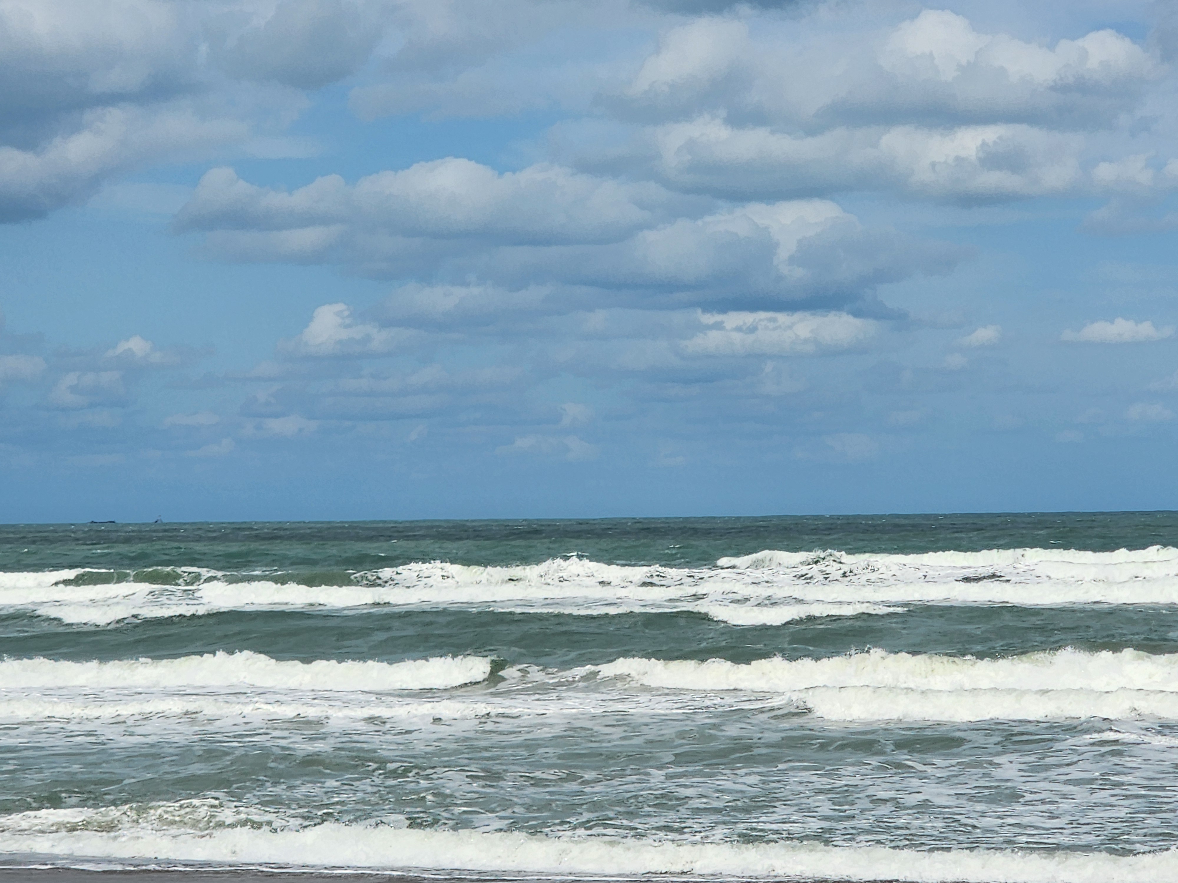 Messy windswell breaking all over the beach with poor form at 31st Street Cocoa Beach lowtide