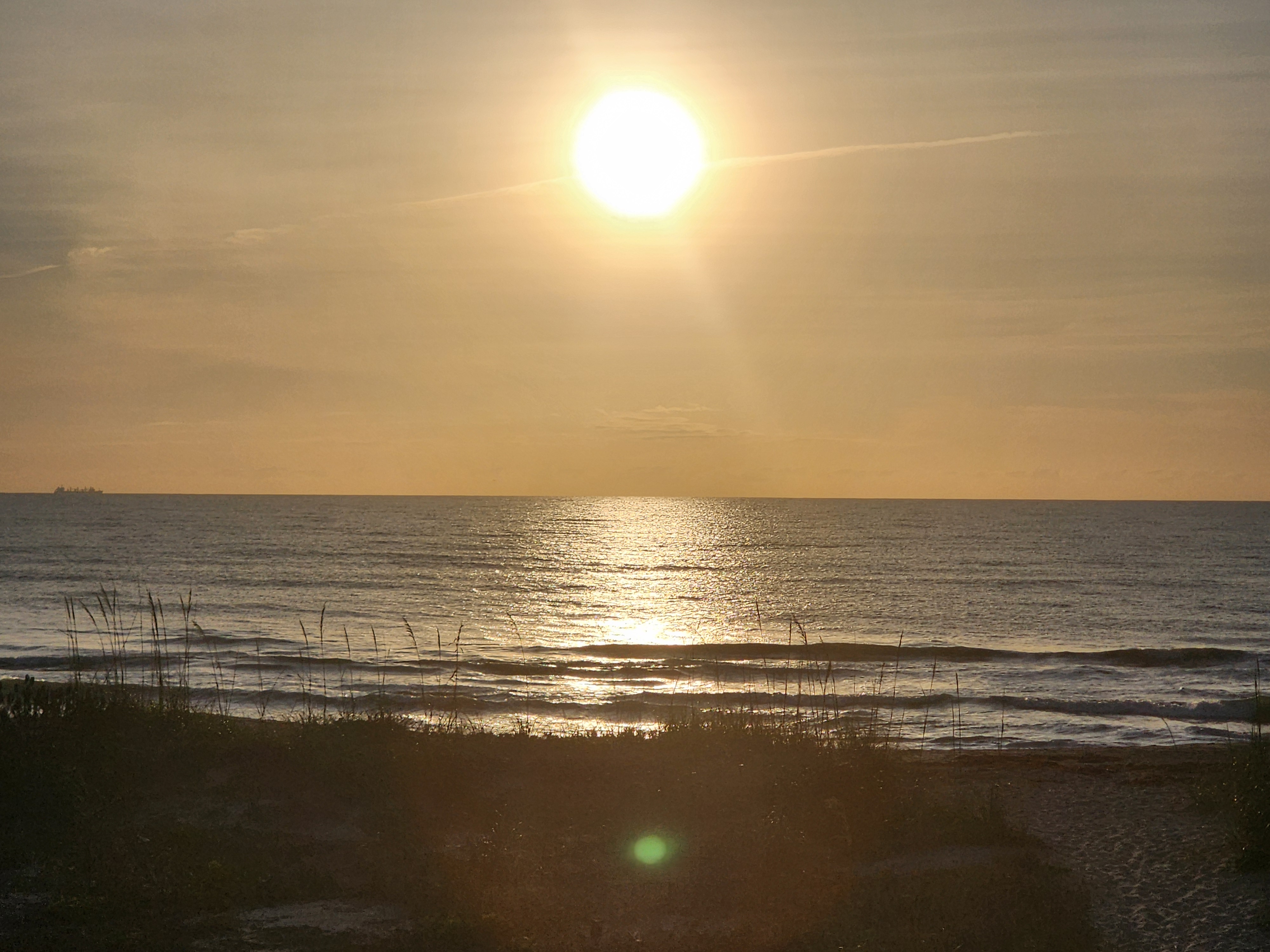 Sunrise over the Atlantic with small clean waves breaking at Picnic Tables South Cocoa Beach May 7 2026