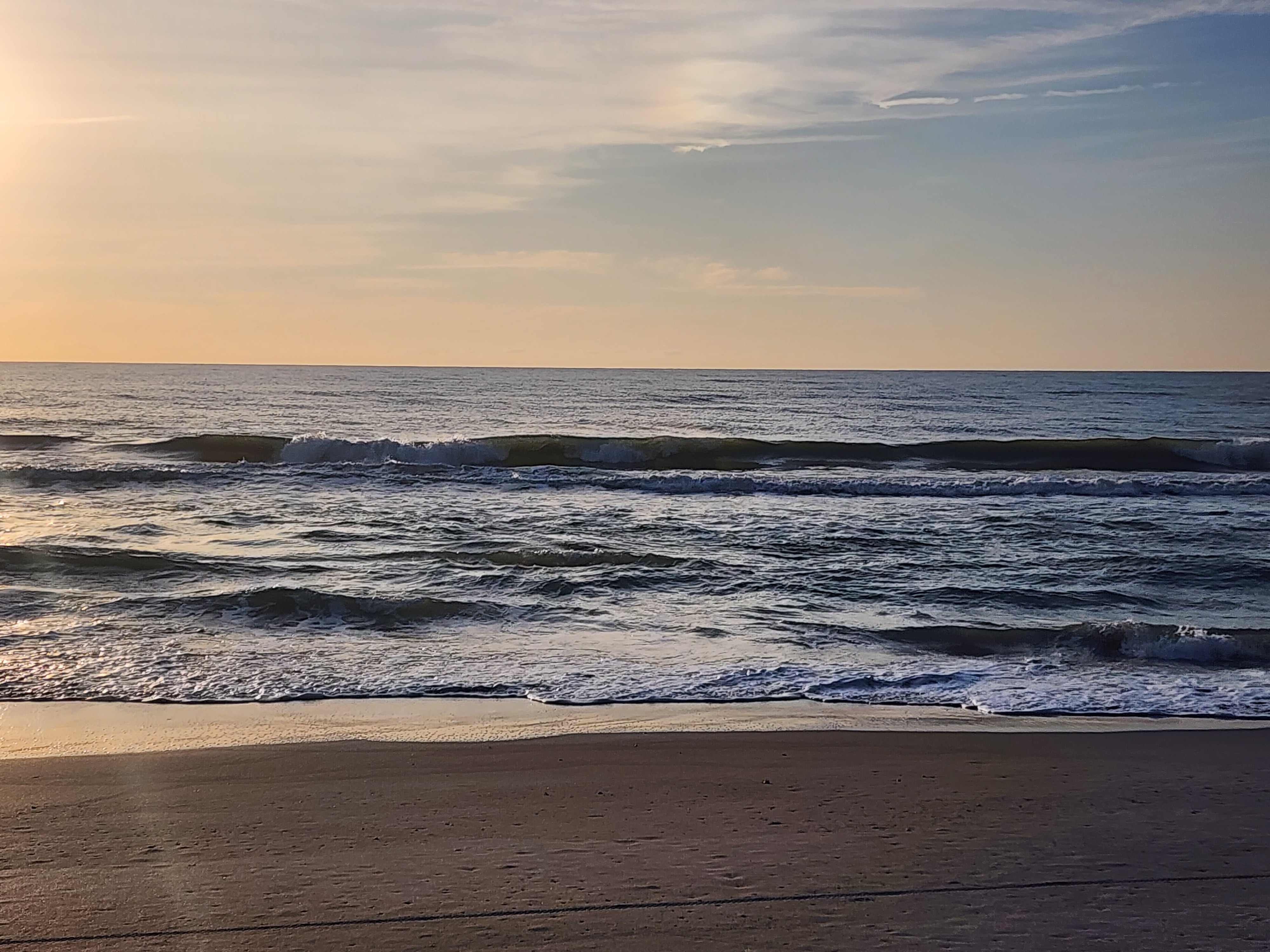 Small clean surf breaking along the shoreline at 31st Street Cocoa Beach calm morning conditions