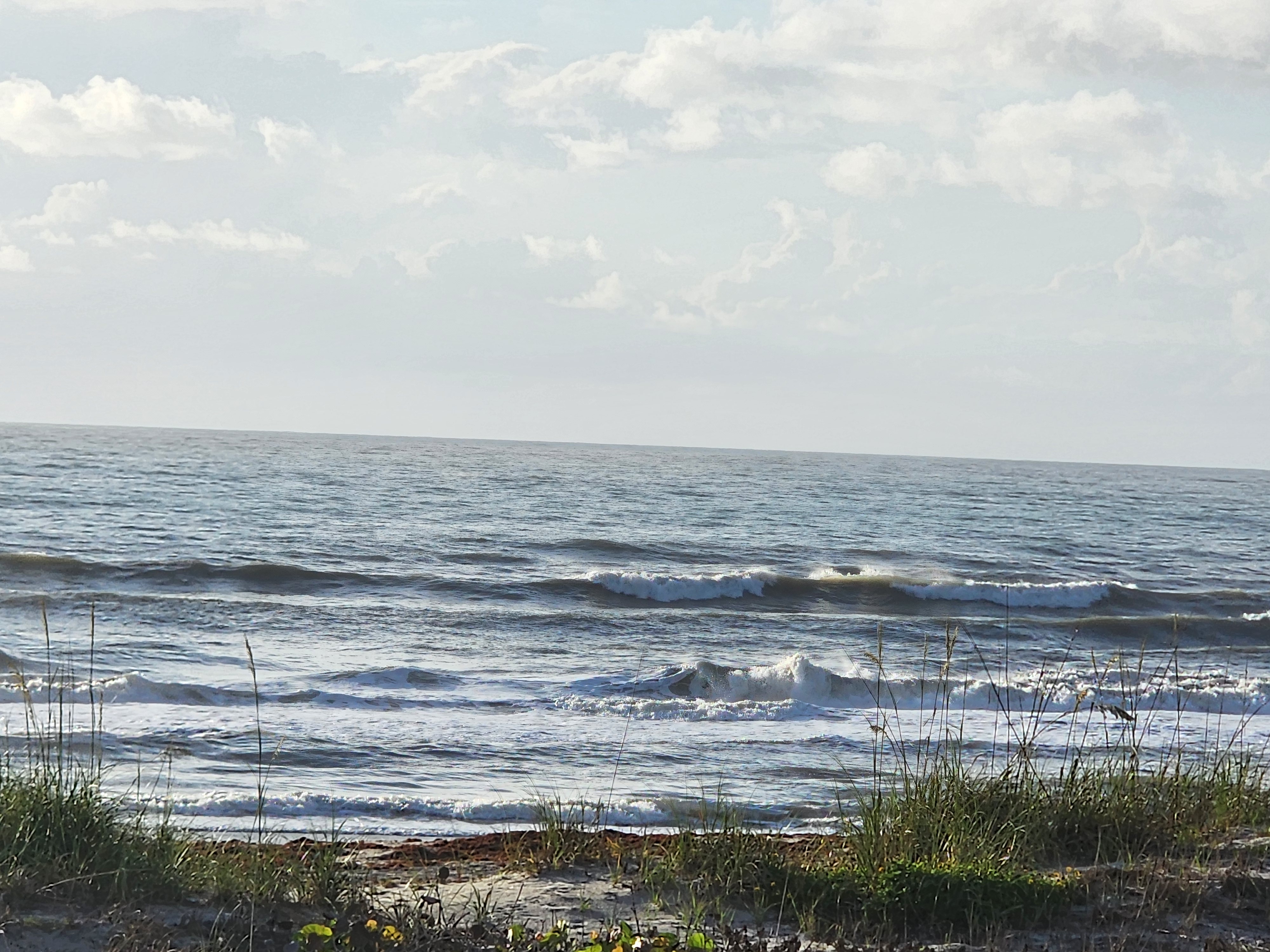Cocoa Beach surf photo 4 — 2-3'+ with light onshore 5 mph or less — fairly clean and fun for shortboard or longboard. Hot day, get out there!