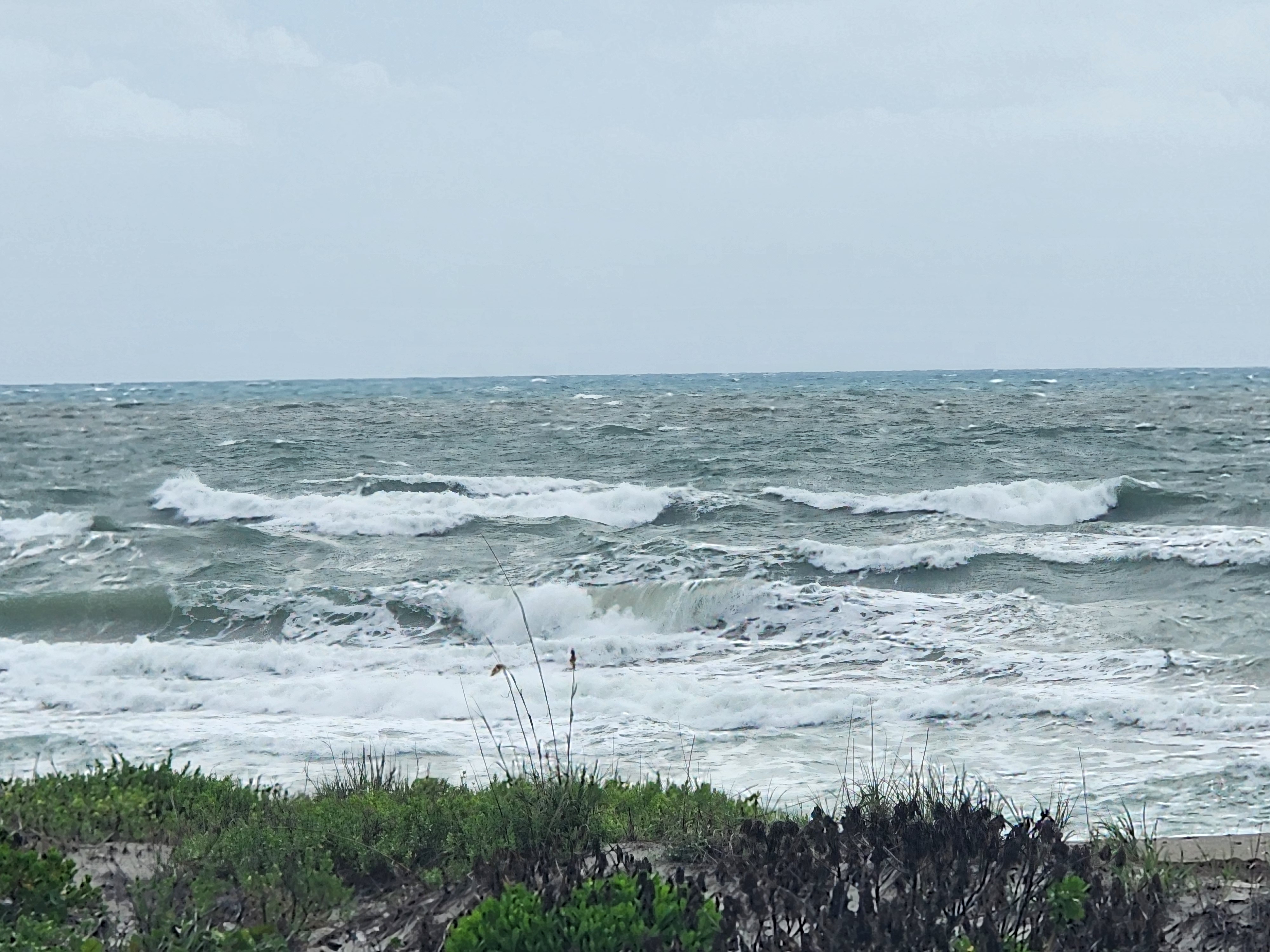 Rough 4-5 foot choppy surf with whitecaps and strong NE winds at South Cocoa Beach June 3 2026