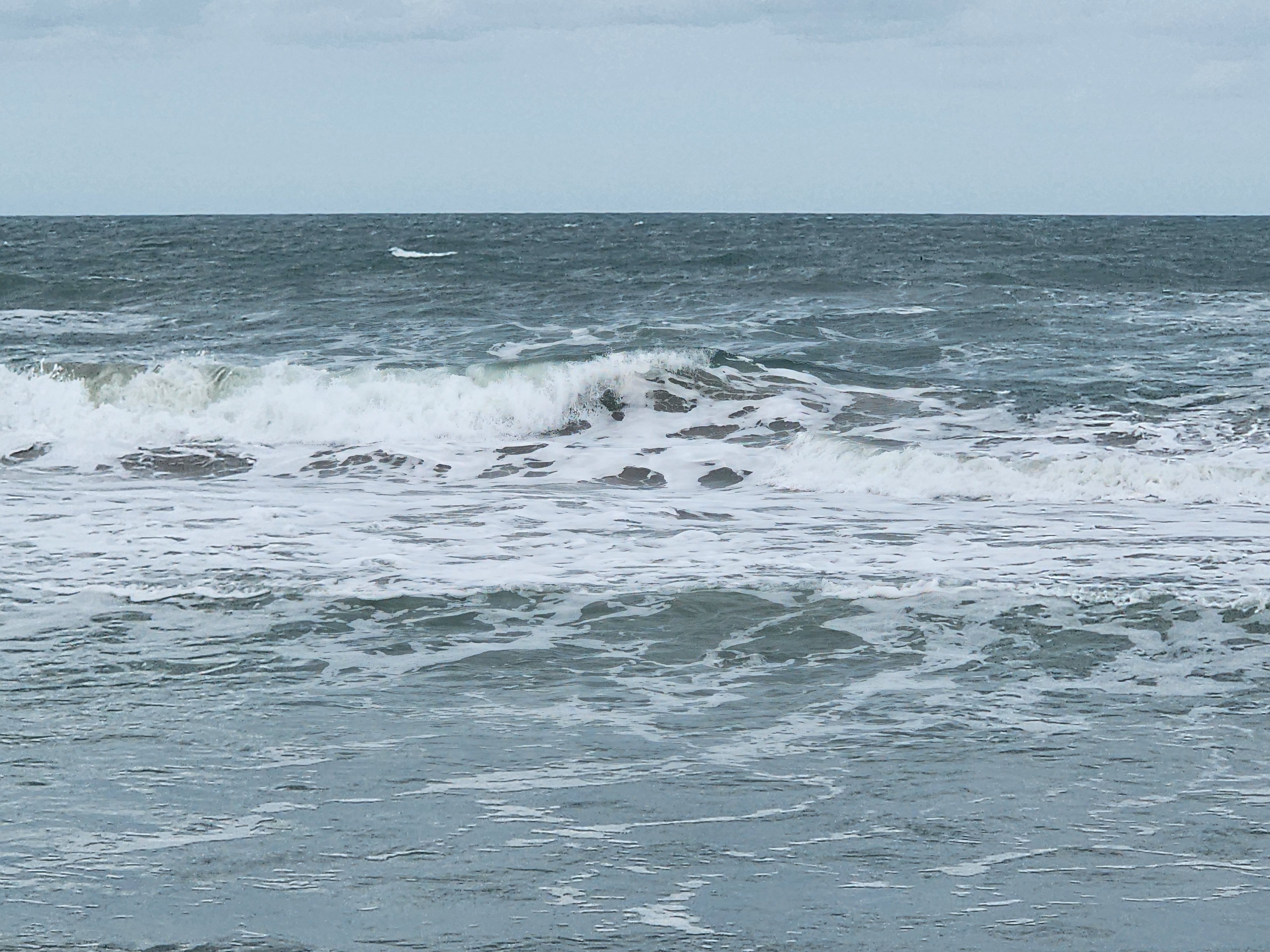 Thick wave breaking close-up with whitewater and dark green face at Picnic Tables Cocoa Beach