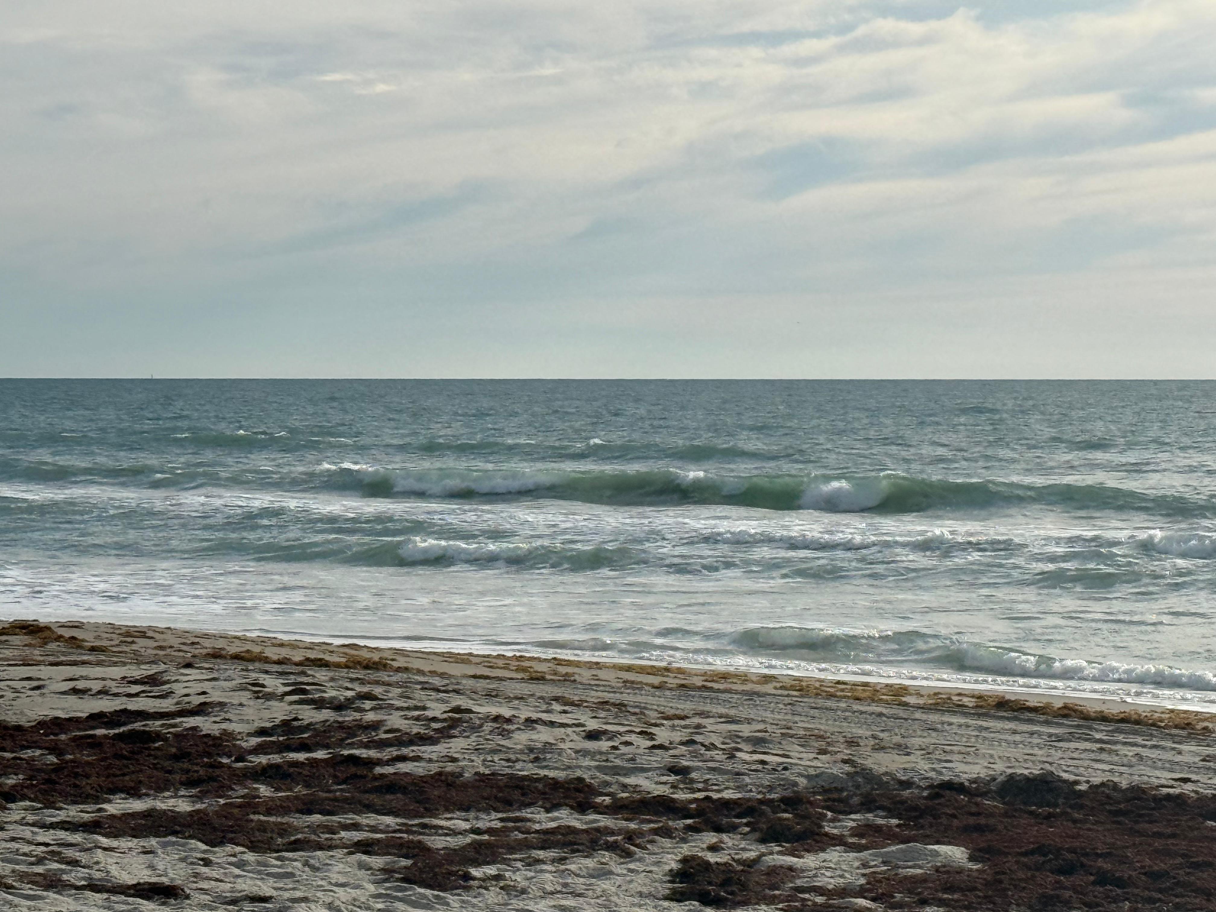 Cocoa Beach surf photo 2 — 8 AM lowtide — 2' onshore chop, swell on the buoys, beautiful day to get out there!