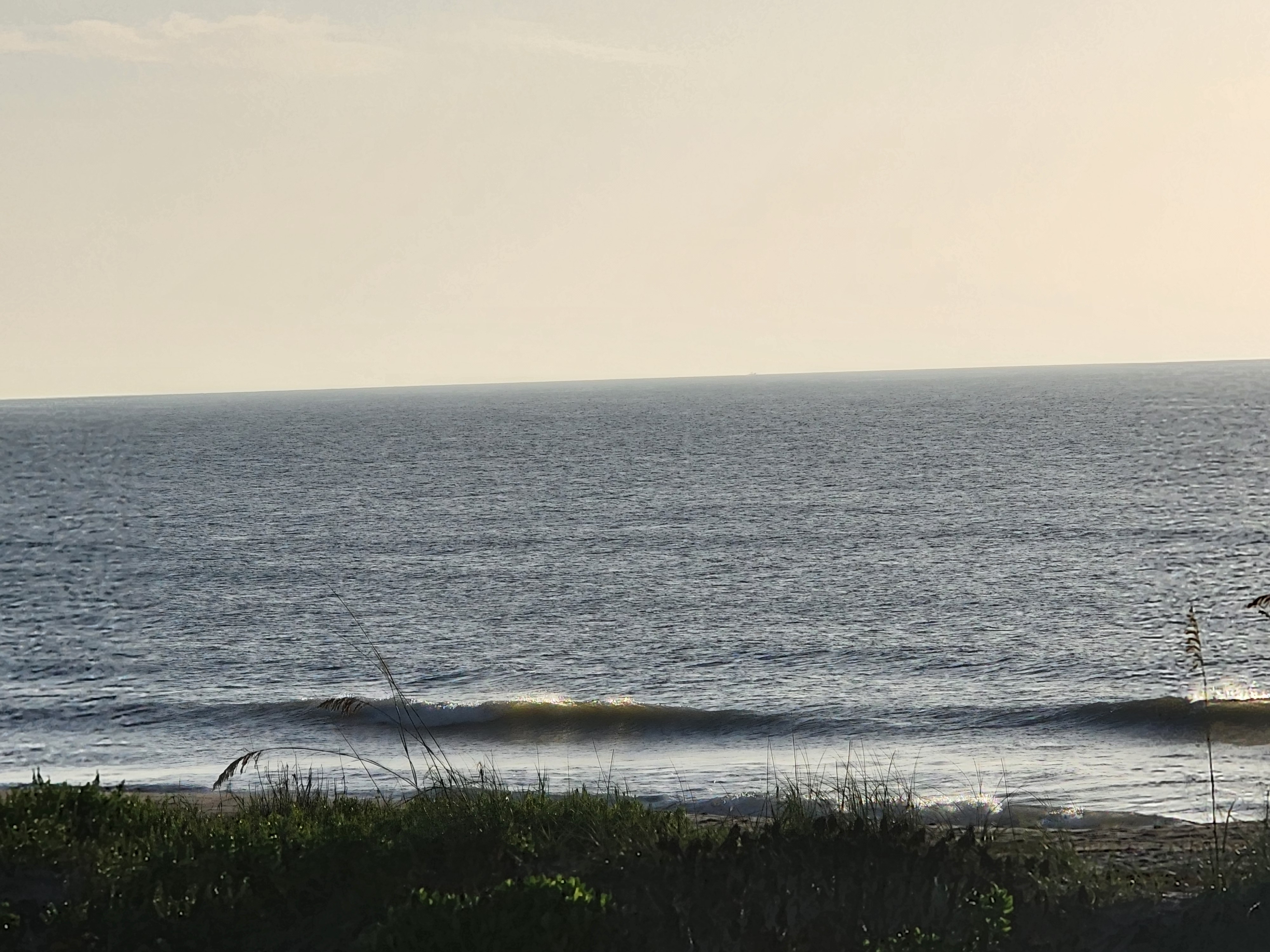 Clean little wave breaking with a ship faint on the horizon near Picnic Tables
