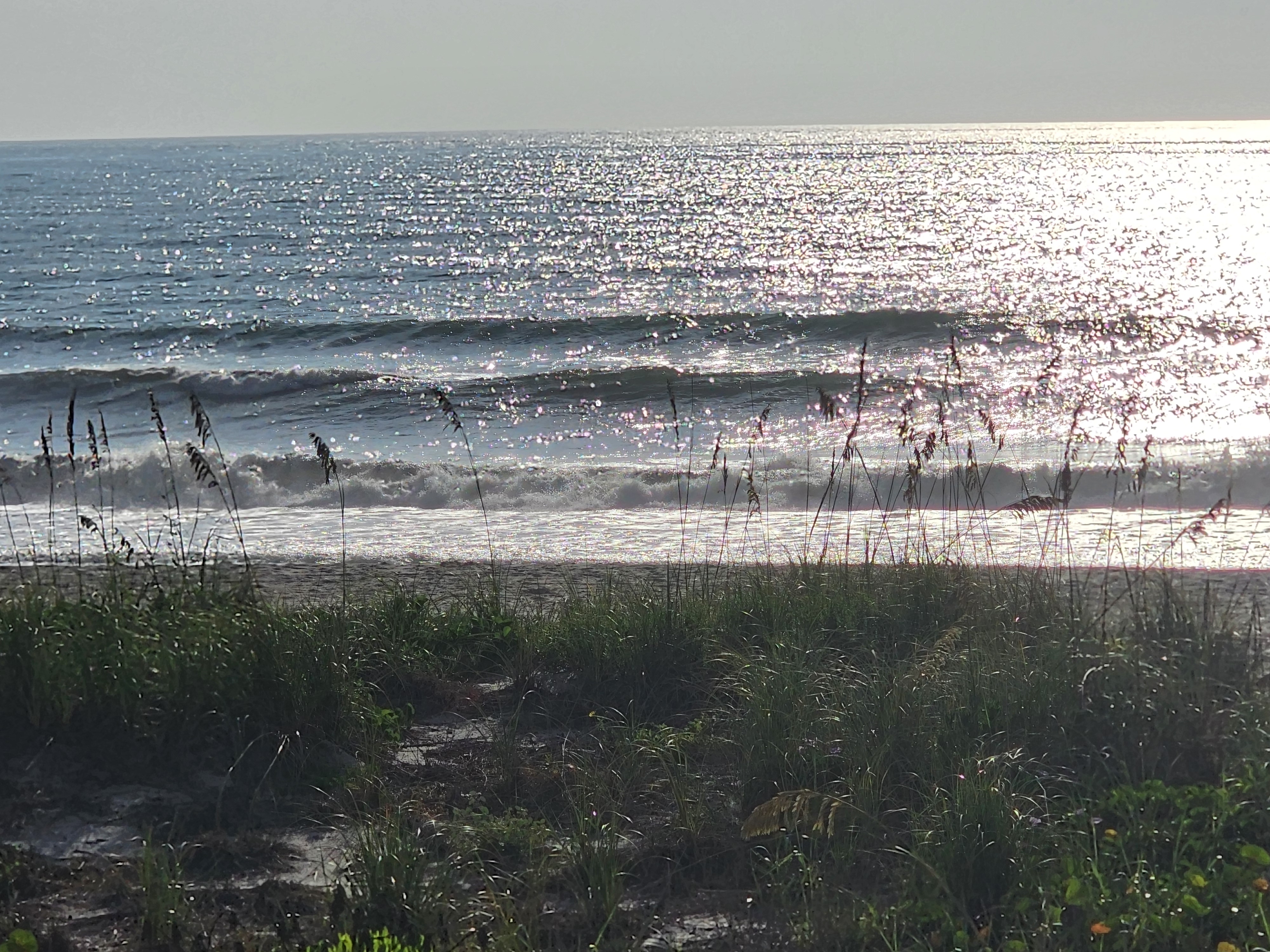 Sun glare sparkling on breaking surf, South Cocoa Beach