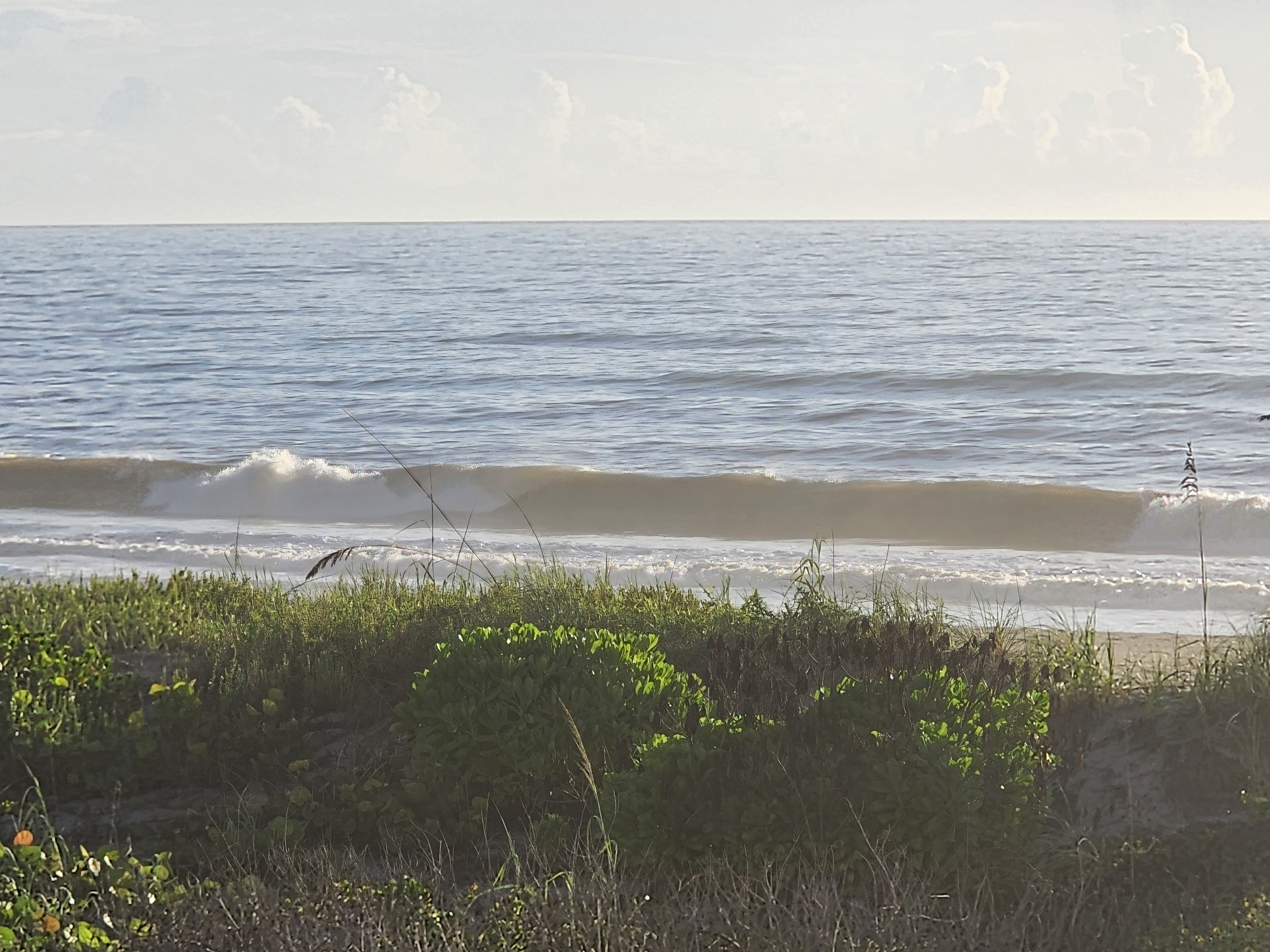 Two foot wave peeling over the sandbar with light east wind bump at Picnic Tables Cocoa Beach best surf spot
