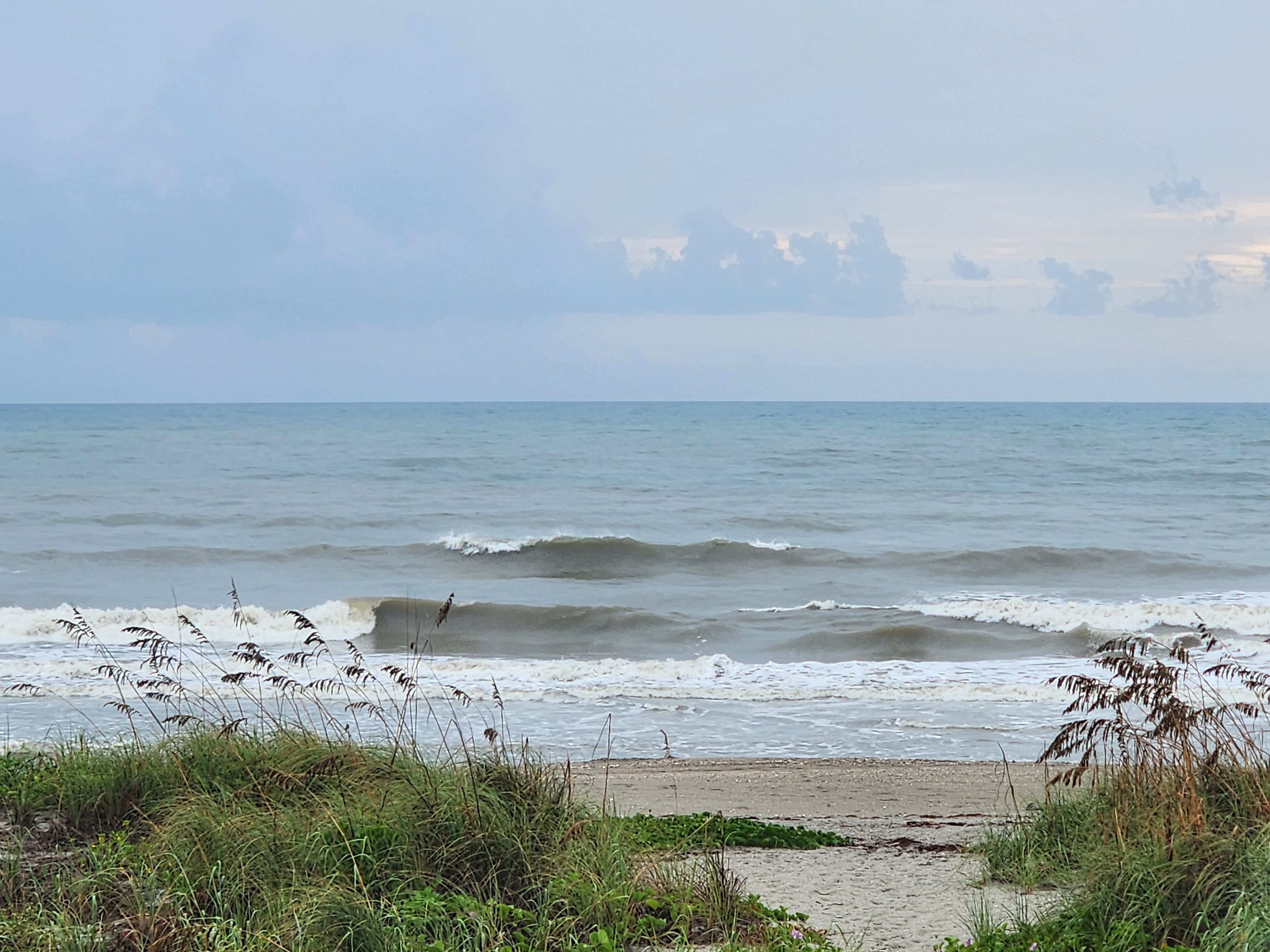 Two lines of waves peeling on the outer and inner bars beyond the dune crossover path